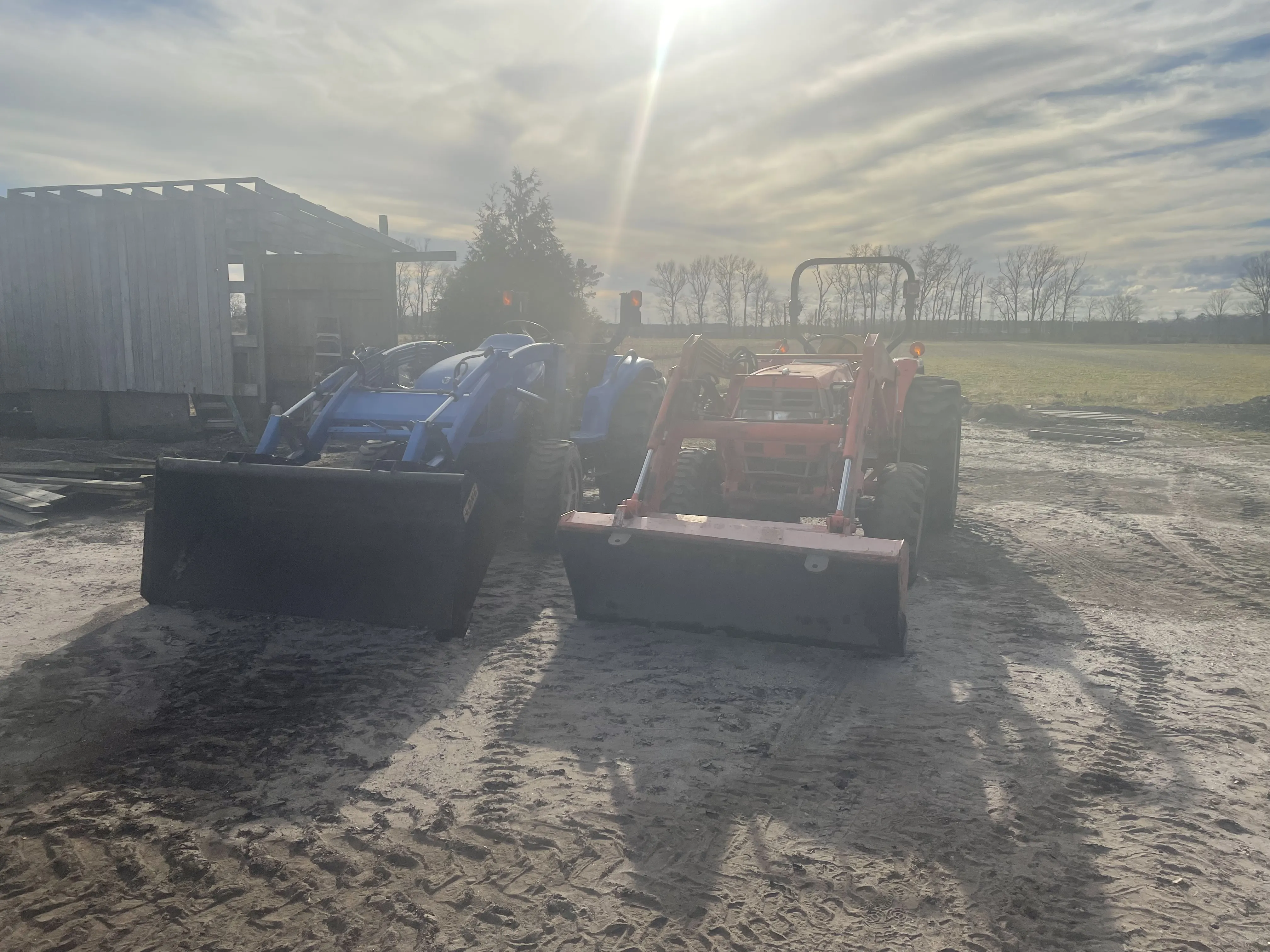 Two tractors in a sandy field