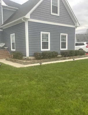 Residential home with green lawn and landscaping