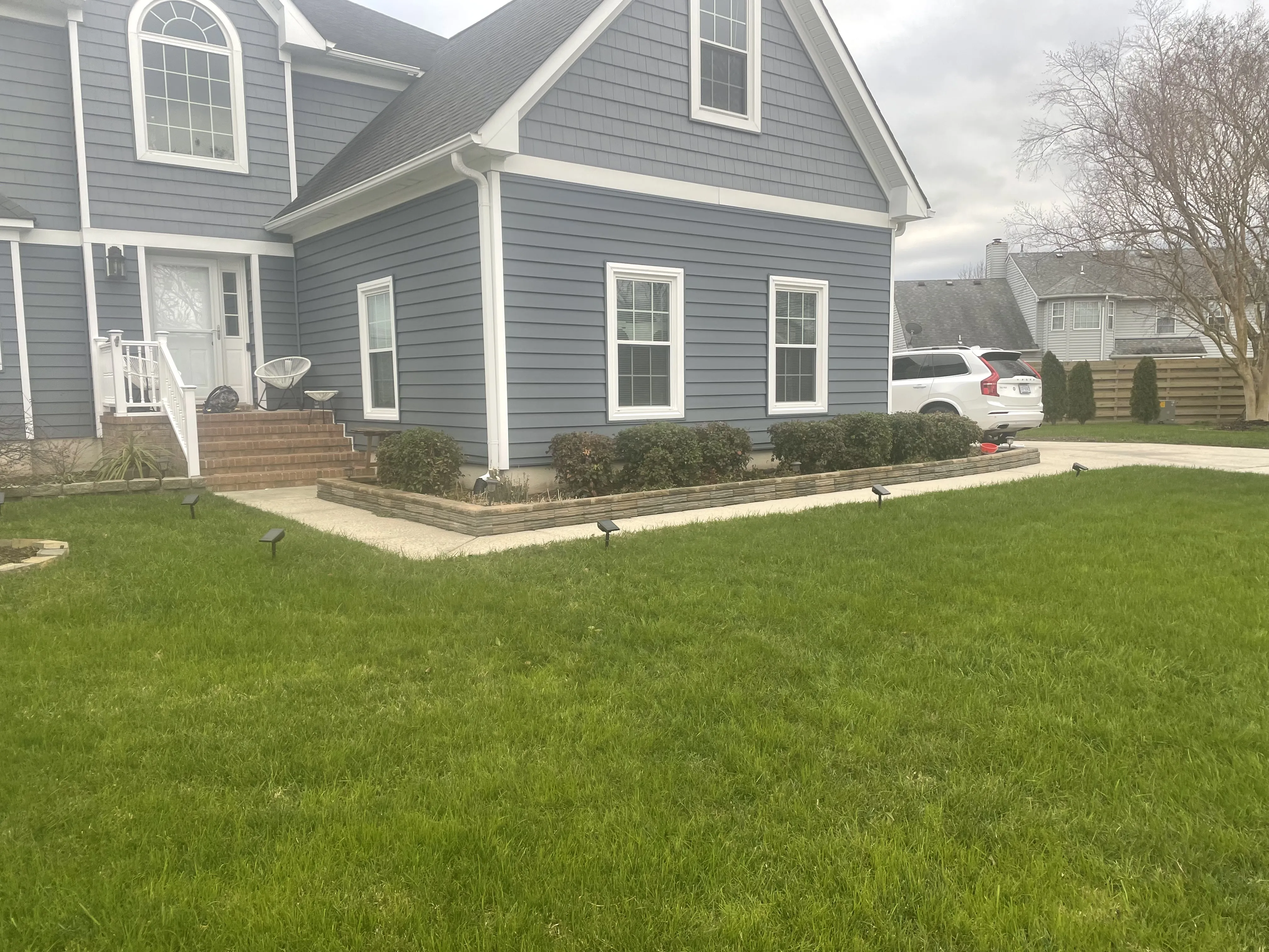 Residential home with green lawn and landscaping