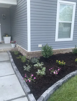 Freshly landscaped garden bed near front porch