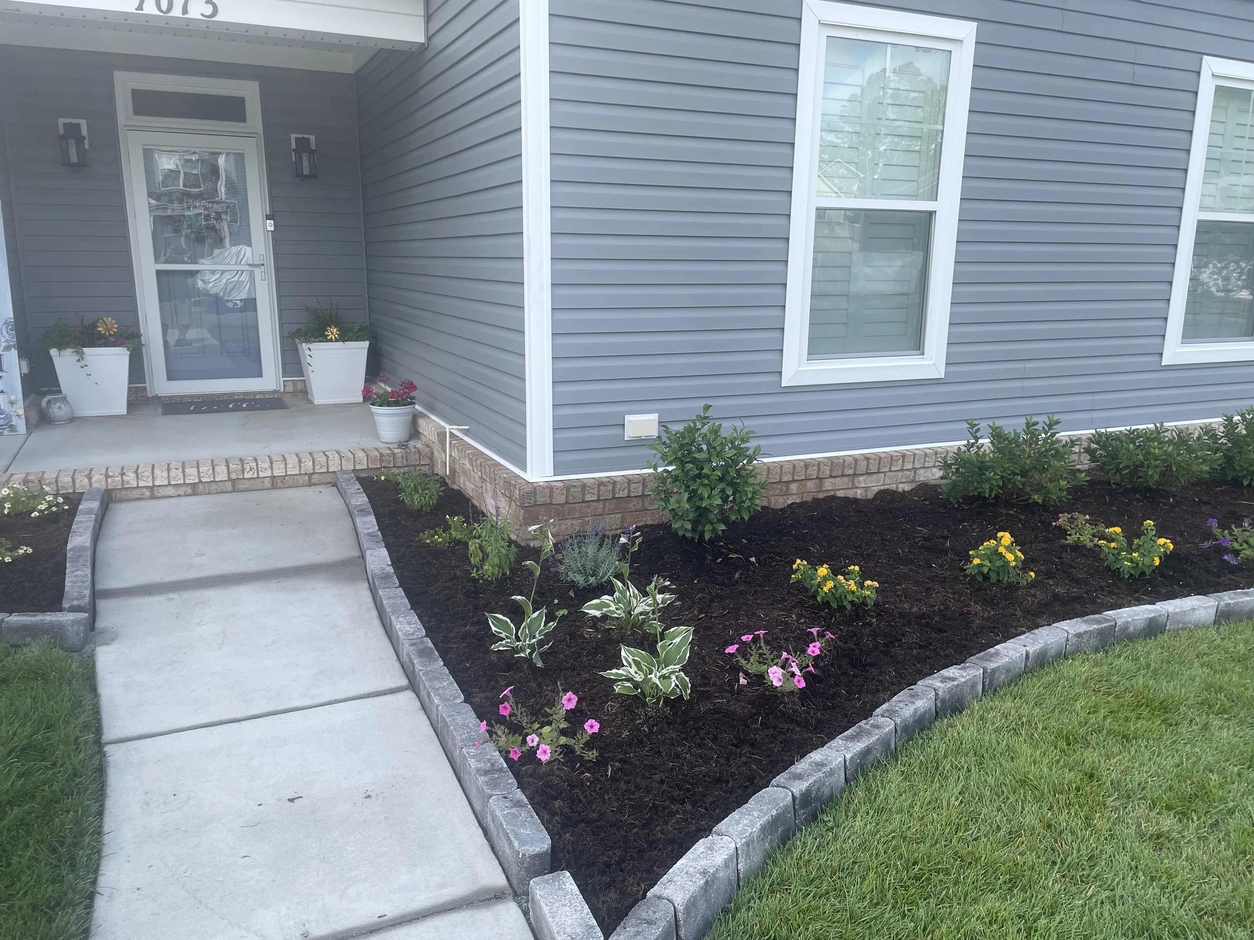 Freshly landscaped garden bed near front porch