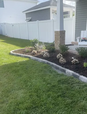 Front porch garden bed with small flowers and plants